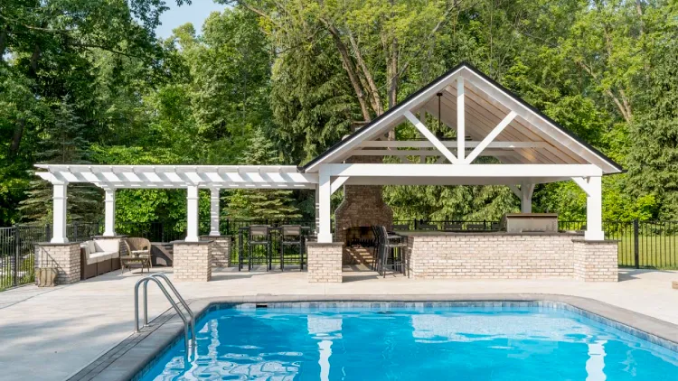 Outdoor kitchen and patio construction with retaining walls in Bainbridge Township featuring quality hardscaping