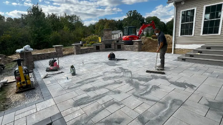 Natural stone patio installation and outdoor living space construction in Burton with custom hardscaping
