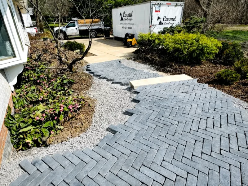 Custom walkway installation on a residential side yard with landscape design by Carmel Landscapes