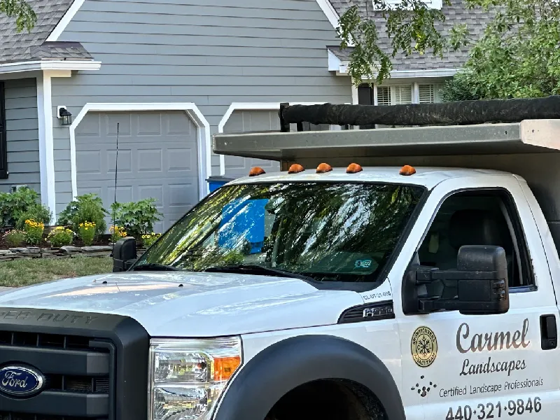 A Carmel Landscapes work truck parked in front of a residential home in Northeast Ohio