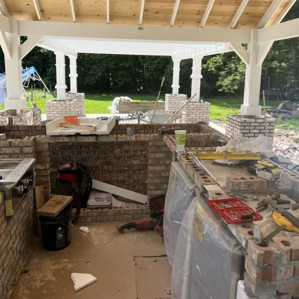 work in progress - outdoor kitchen construction, brick and mortar, hardscape construction workspace.