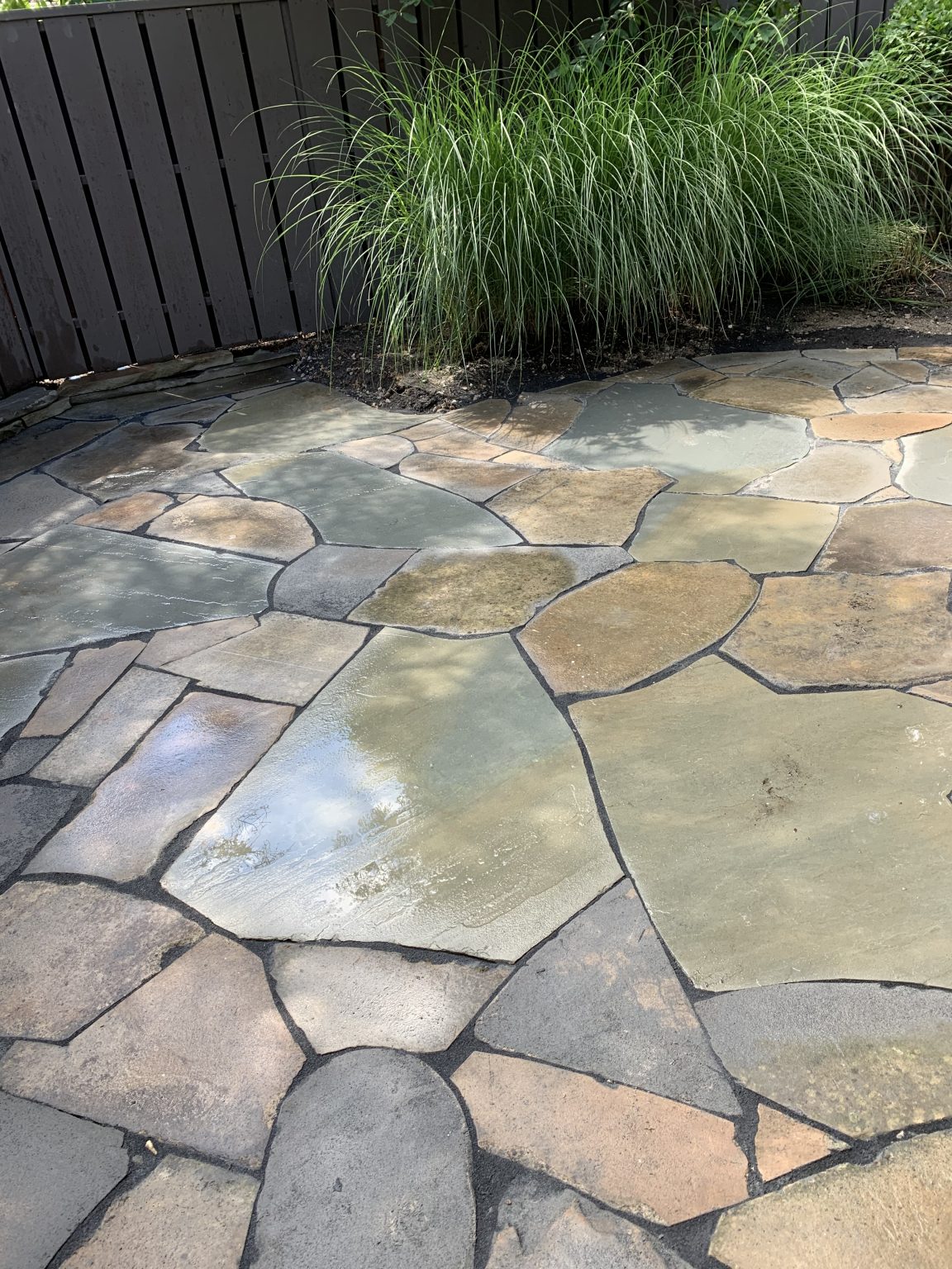 A Sandstone and bluestone patio, married together by Carmel Landscapes in Aurora Ohio.